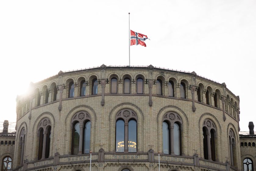 På toppen av stortingsbygningen vaier flagget på halv stang.