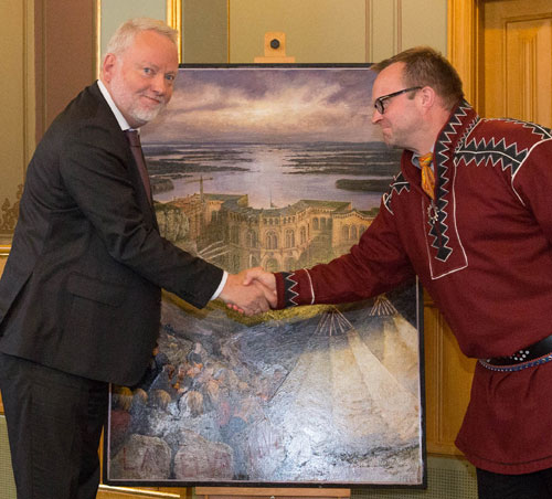 Riksantikvar Jørn Holme overrekker maleriet «La elva leve» av Rolf Groven til Sametinget. Plenumsleder Jørn Are Gaski takker for gaven.