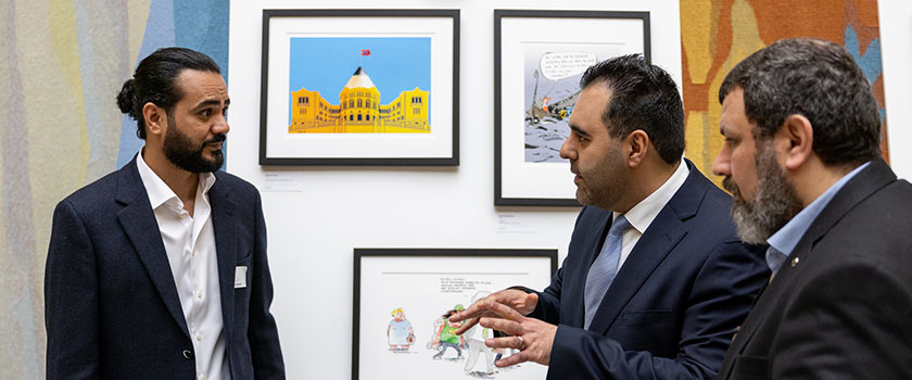 Cartoonist Ahmed Falah talking to President of the Storting Masud Gharahkhani.
